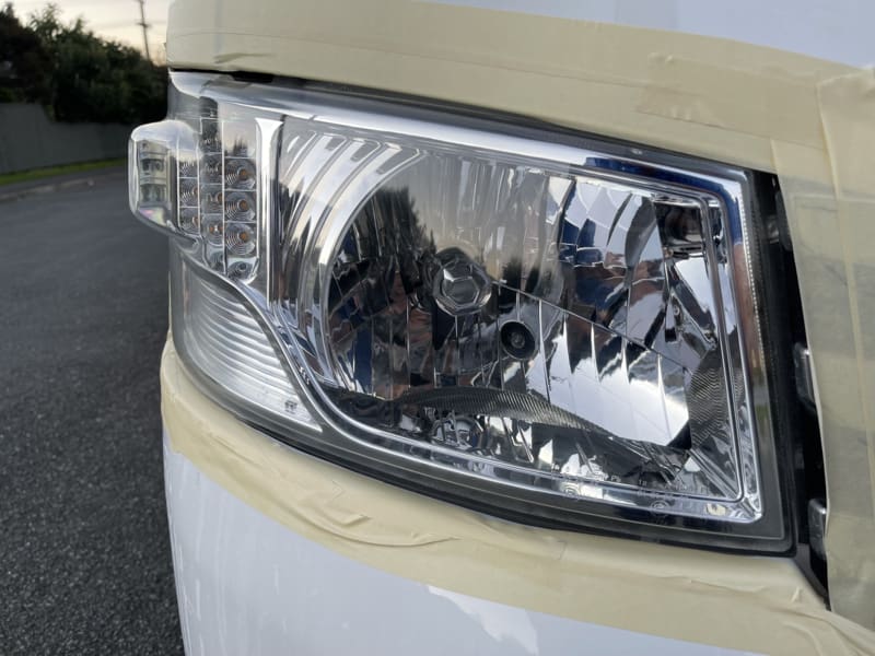 The left hand main light of a vehicle, visually restored and bright looking.