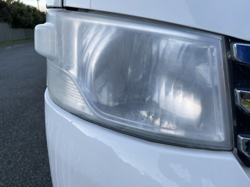 Headlight before restoration showing heavy yellowing
