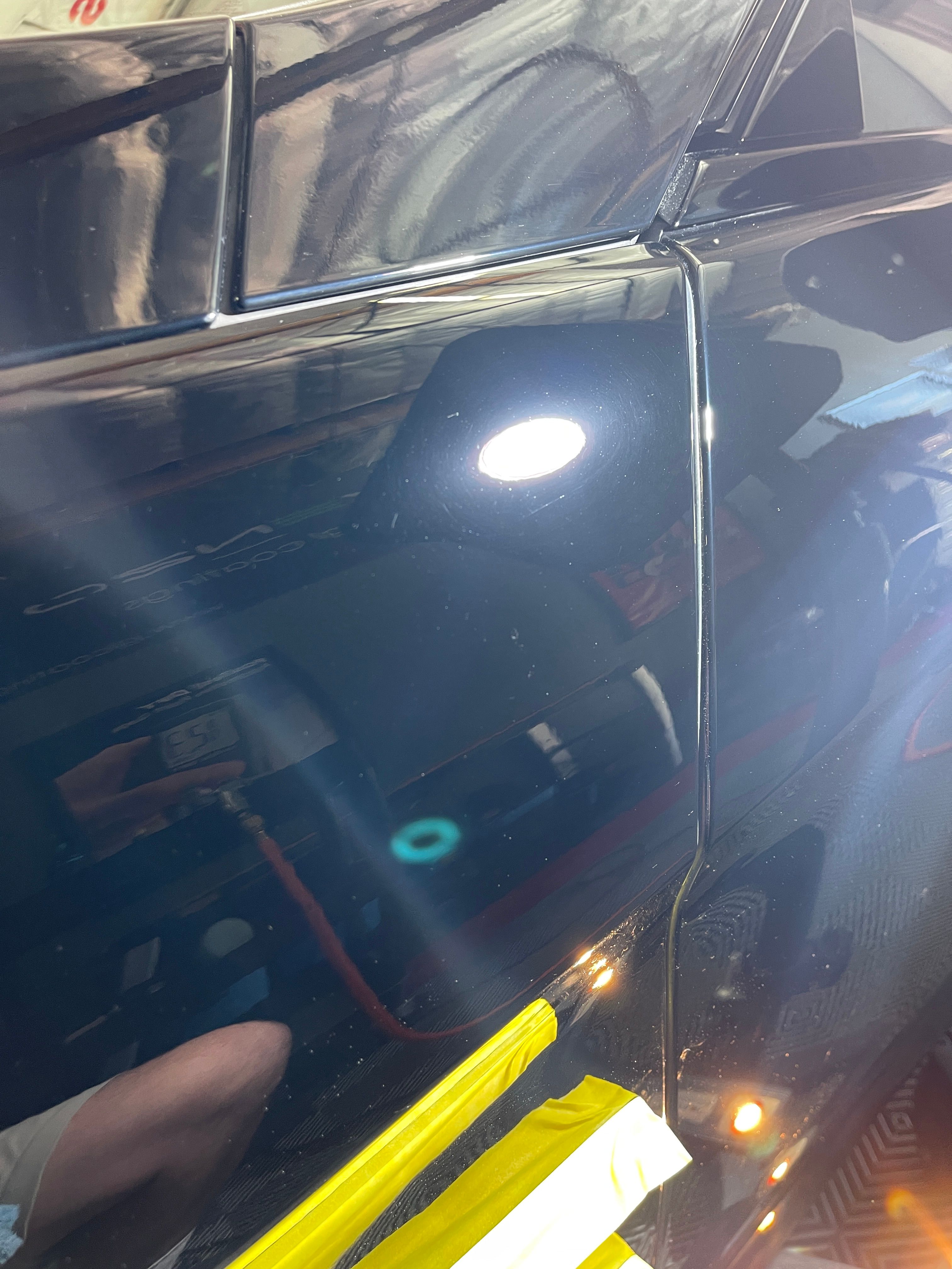 Mercedes SL550 black paint after professional paint correction showing mirror-like finish with all scratches removed