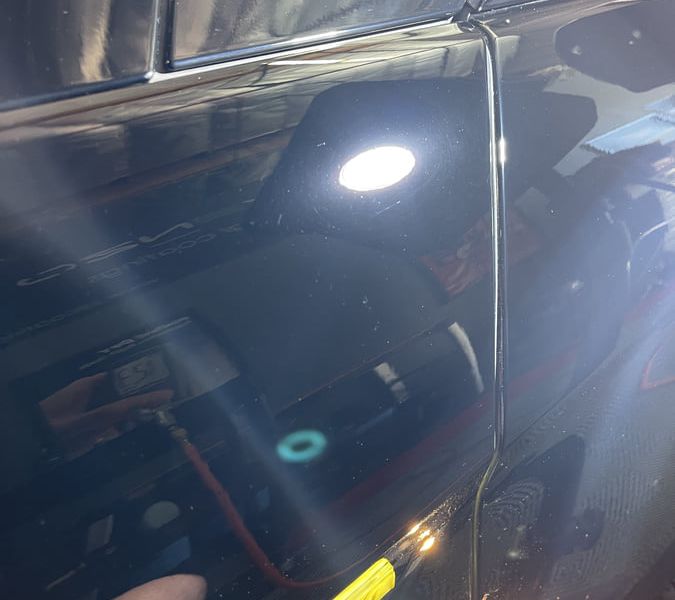 The same Mercedes SL550 panel after multi-stage correction, reflecting evenly
