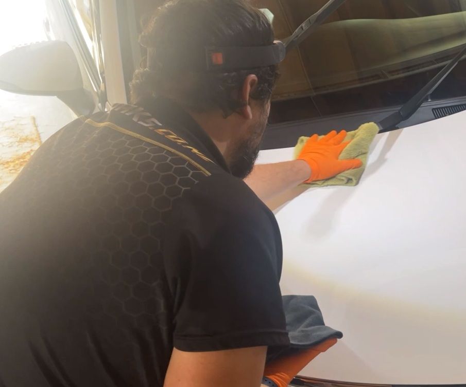 Aaron buffing ceramic coating with specialized equipment requiring specialty microfiber cloths, PPE, and specialized lighting