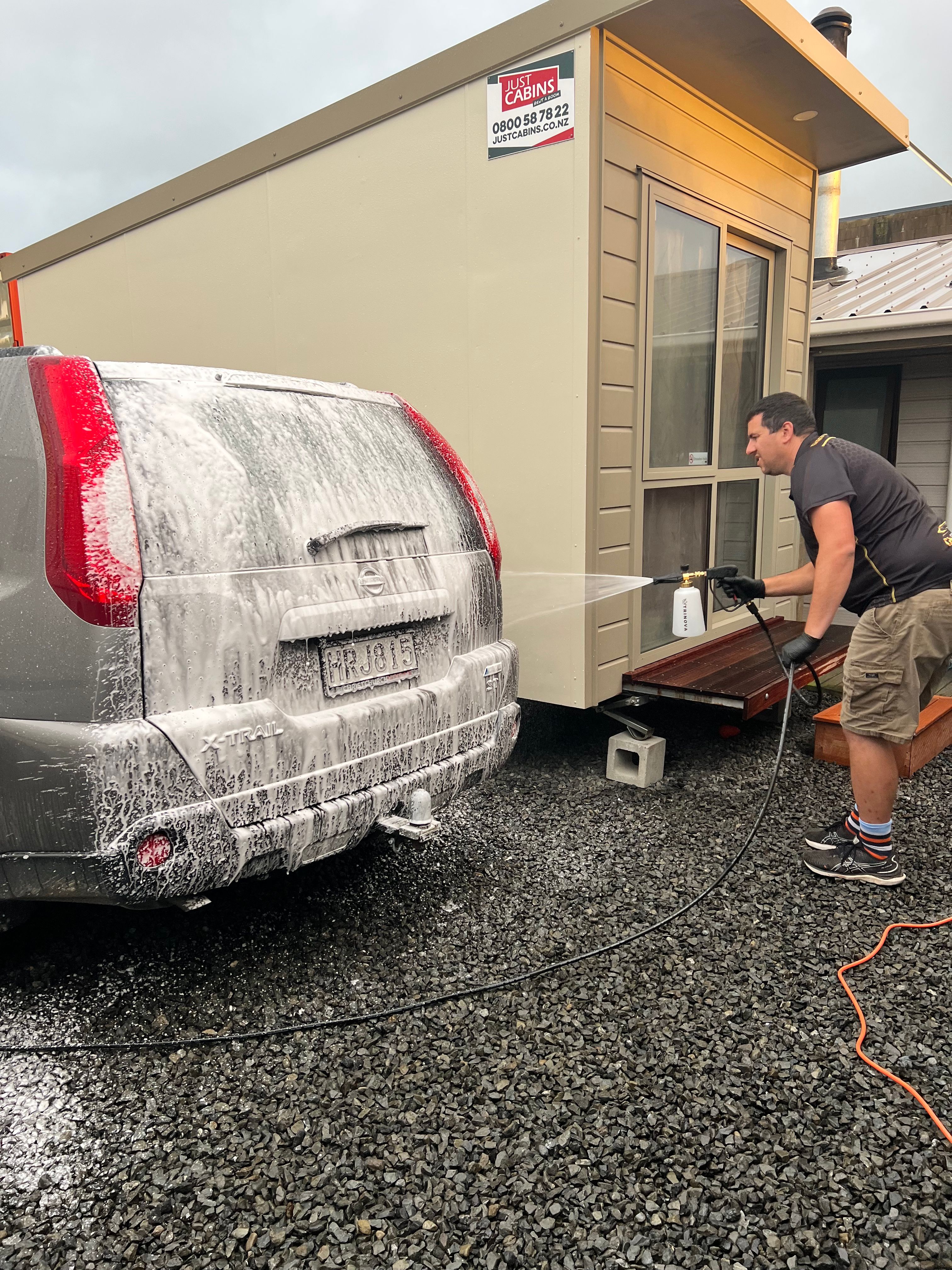 Aaron snow foaming a vehicle during pre-wash process showing that proper maintenance is essential even with ceramic coating