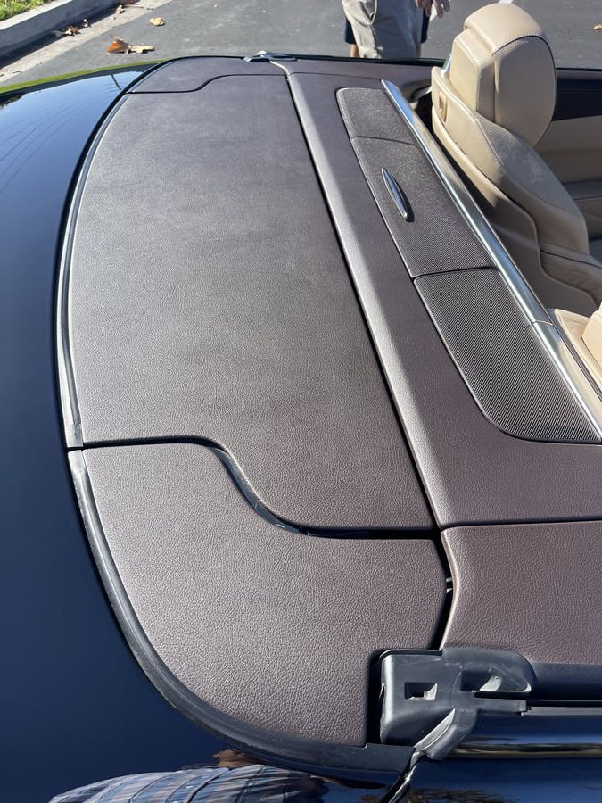 Restored Mercedes SL550 interior plastic trim showing renewed original color and texture after professional restoration