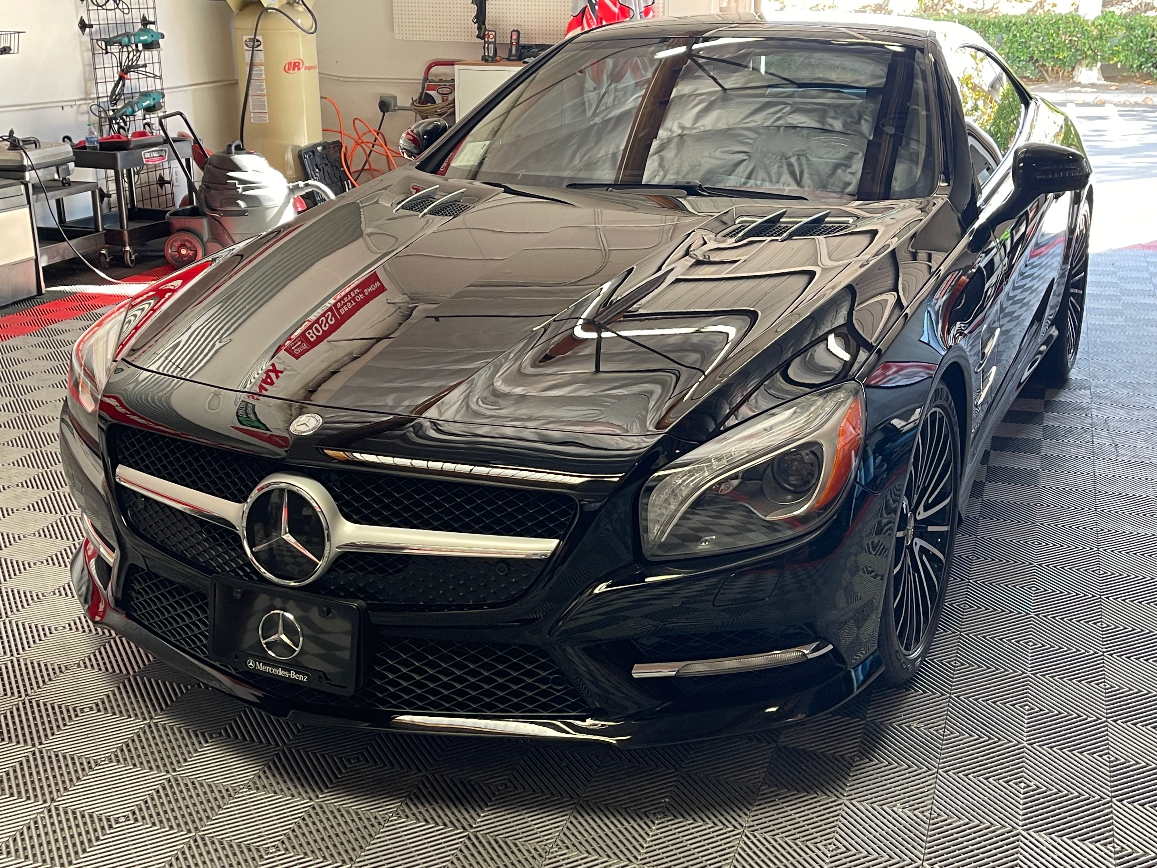 Completed Mercedes SL550 restoration showing pristine black paint with ceramic coating