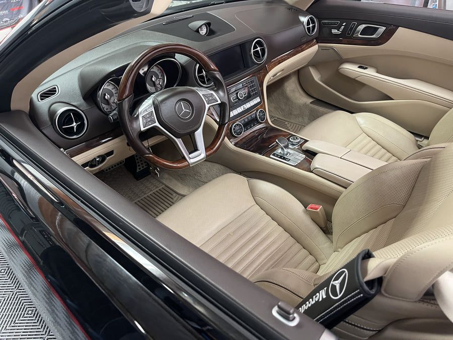 Pristine Mercedes SL550 interior after complete restoration showing clean leather seats, renewed trim, and showroom condition