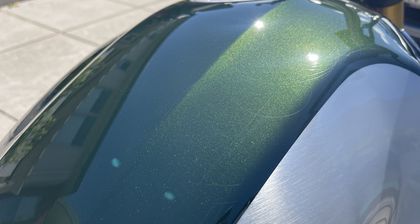 Scratches and marking visible across a paint surface in direct light