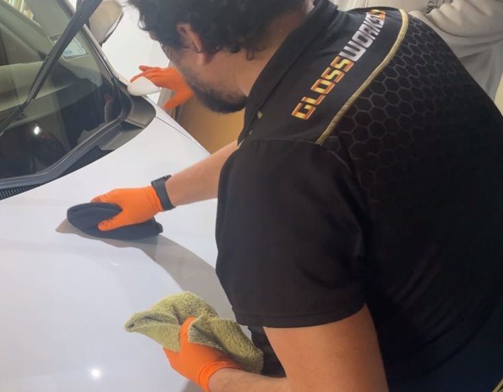Aaron and team member applying ceramic coating demonstrating professional teamwork and coordinated technique
