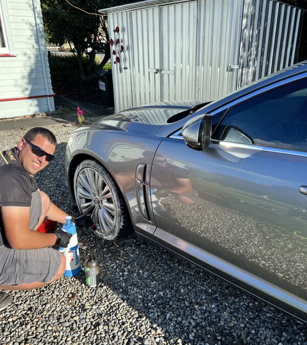 Silver Jaguar Vehicle being cleaned by Aaron at Glossworks